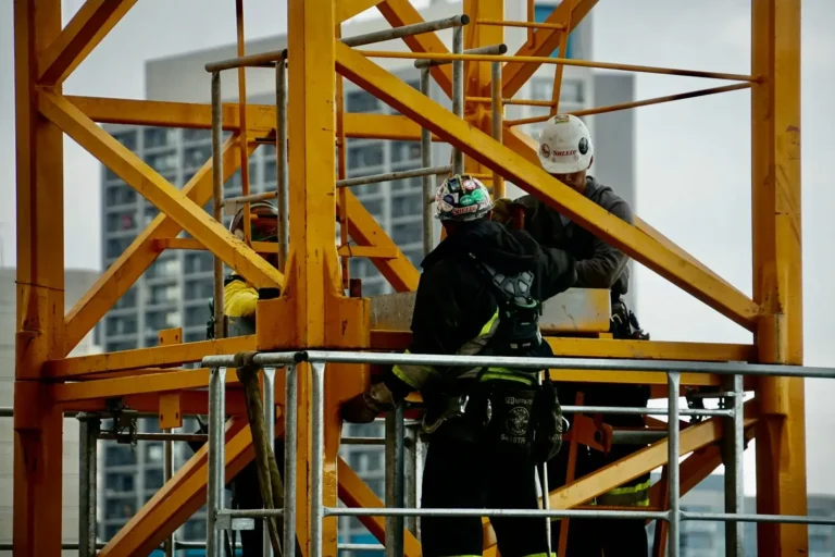 Construction workers on crane structure supporting technical site delivery - InnoFund - R&D Tax & Innovation Funding